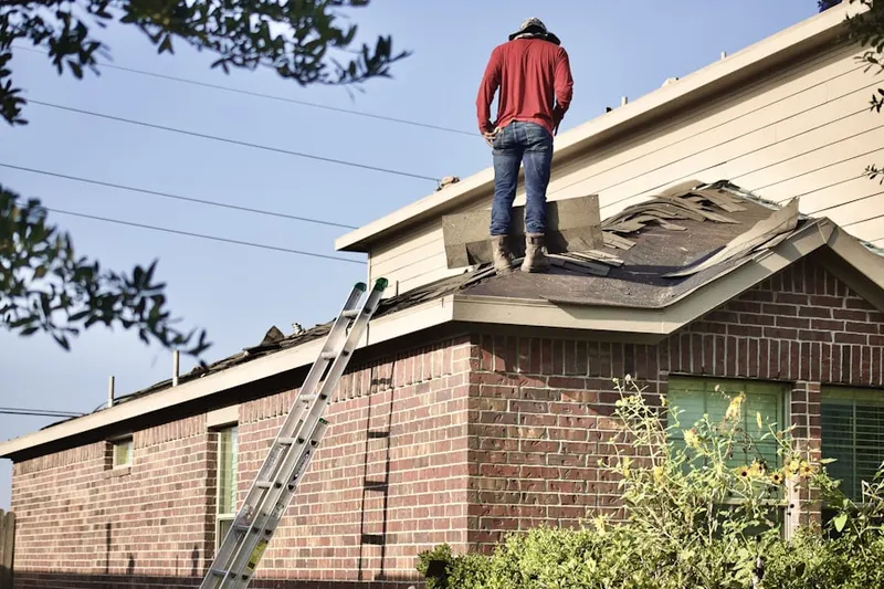 Professional roofer working on a residential roof in Indian Neck